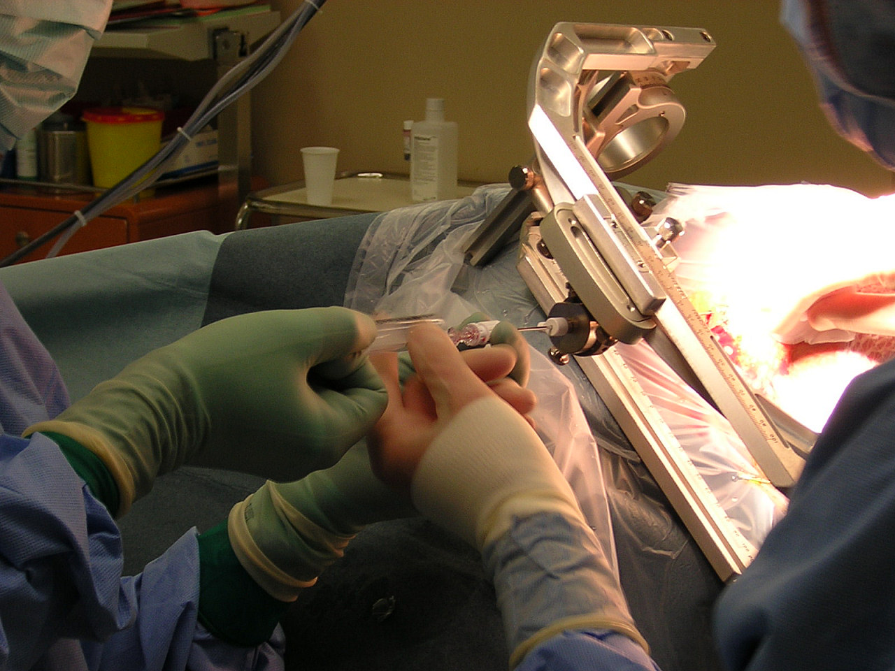 Surgeon performing surgery under bright operating light
